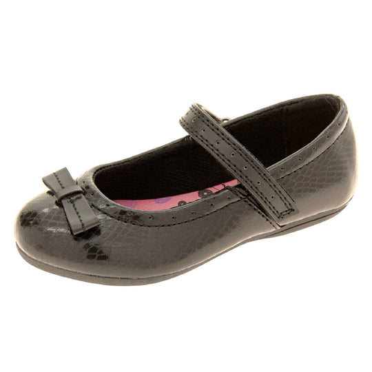 Girls Black School Shoes. Black Mary Jane shoes with a moc croc detail and a bow to the front. Black touch fasten strap over the foot and a pink insole. Left foot at an angle