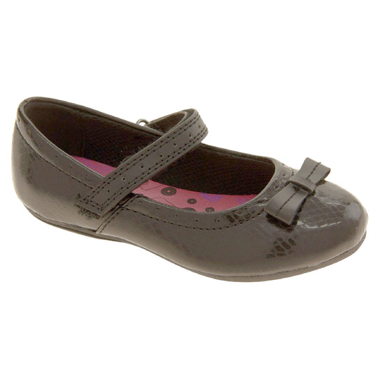 Girls Black School Shoes. Black Mary Jane shoes with a moc croc detail and a bow to the front. Black touch fasten strap over the foot and a pink insole. Right foot at angle
