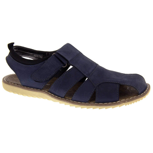Mens leather sandals. Classic sandal with a navy blue leather upper. Closed toe but with straps to give a cut outs down the side to keep feet cool. Touch close fastening ankle strap. With a brown insole and sand coloured outsole. Right foot at an angle.