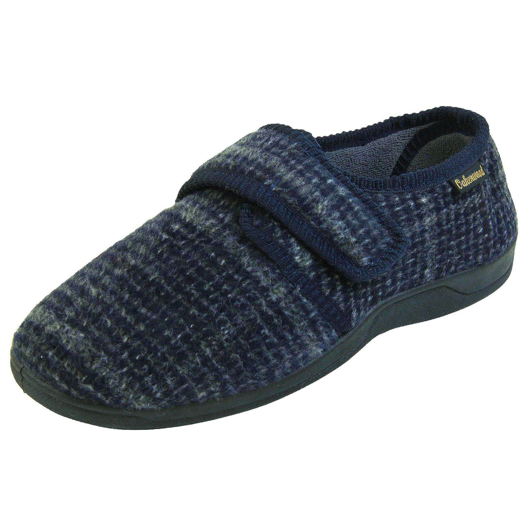 Adjustable memory foam slippers. Mens full back slippers with a blue check upper and blue edging around the strap and collar of the shoe. Touch fasten strap across the bridge of the foot. Chunky black synthetic sole. Left foot at an angle.