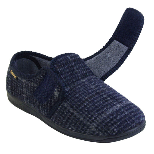 Adjustable memory foam slippers. Mens full back slippers with a blue check upper and blue edging around the strap and collar of the shoe. Touch fasten strap across the bridge of the foot. Chunky black synthetic sole. Right foot at an angle with the strap undone.
