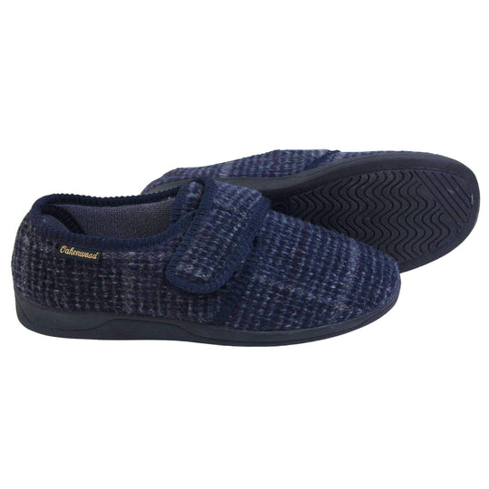 Adjustable memory foam slippers. Mens full back slippers with a blue check upper and blue edging around the strap and collar of the shoe. Touch fasten strap across the bridge of the foot. Chunky black synthetic sole. Both feet from side profile with left foot on its side to show the sole.