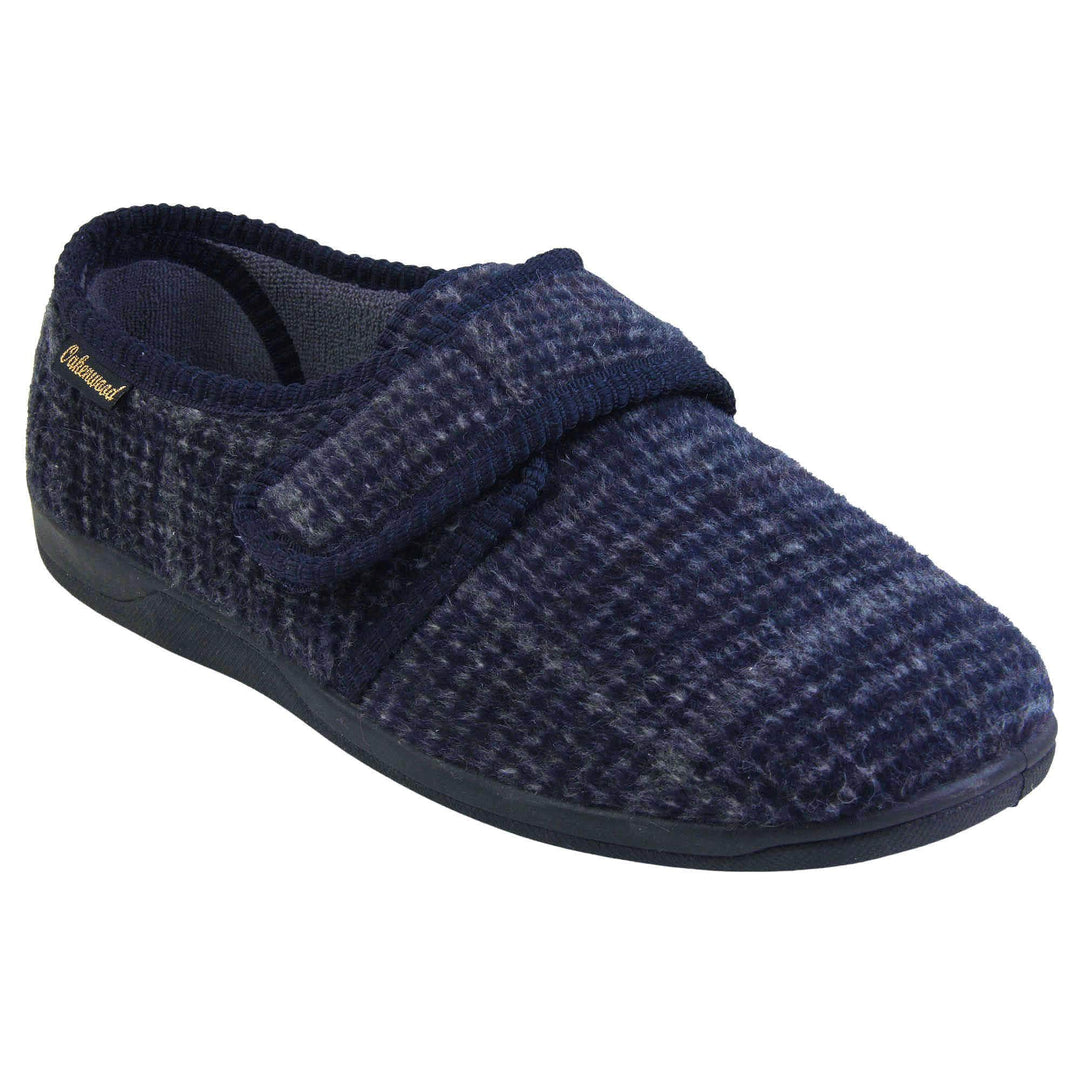 Adjustable memory foam slippers. Mens full back slippers with a blue check upper and blue edging around the strap and collar of the shoe. Touch fasten strap across the bridge of the foot. Chunky black synthetic sole. Right foot at an angle.