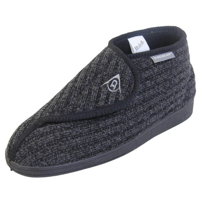 Orthopaedic slippers for men. Mens orthopaedic slippers in an ankle boot style. With a black knit upper and black fleece lining. With an adjustable touch close top with a grey Dunlop logo on. Small grey label to the outer side edge with Dunlop written on. Thick black outdoor sole. Left foot at an angle.