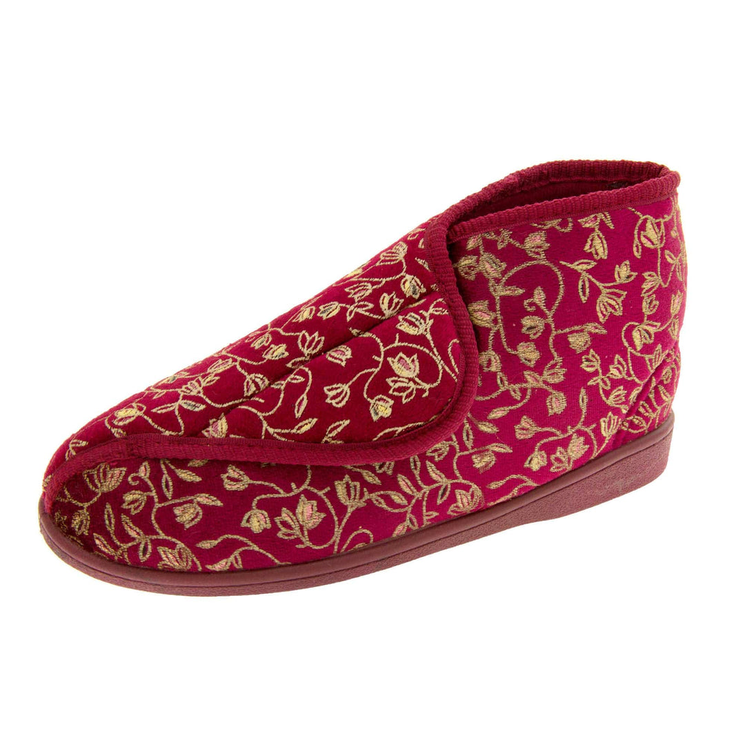 Ankle boot slippers. Womens bootie style slipper with a burgundy textile upper with vine and flower embroidered design and red edging. Touch fasten tab to the top and red textile lining. Firm red sole. Left foot at an angle.