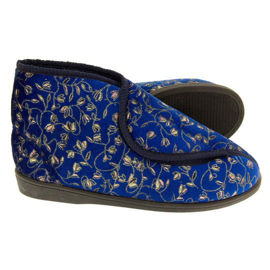 Ankle slippers. Womens bootie style slipper with a navy blue textile upper with vine and flower embroidered design and black edging. Touch fasten tab to the top and blue textile lining. Firm black sole. Both feet from a side profile with the left foot on its side behind the the right foot to show the sole.