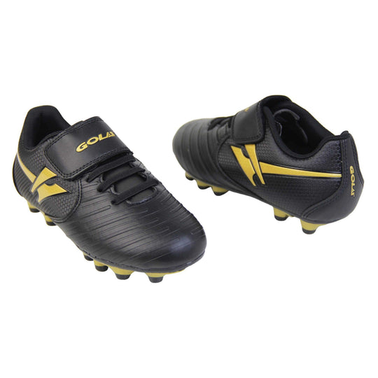 Kids football boots. Black football boots with line detailing to the toes. Touch close fastening and elasticated lace detail to the front. Gold Gola logo to the side and gold Gola branding to the touch fasten strap. Black sole with gold accents and studs to the base. Both feet facing top to tale from an angle.
