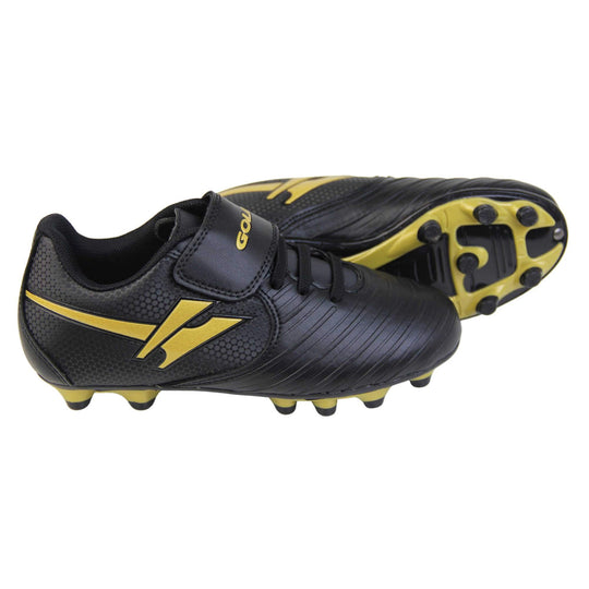 Kids football boots. Black football boots with line detailing to the toes. Touch close fastening and elasticated lace detail to the front. Gold Gola logo to the side and gold Gola branding to the touch fasten strap. Black sole with gold accents and studs to the base. Both feet from side profile with the left foot on its side to show the sole.