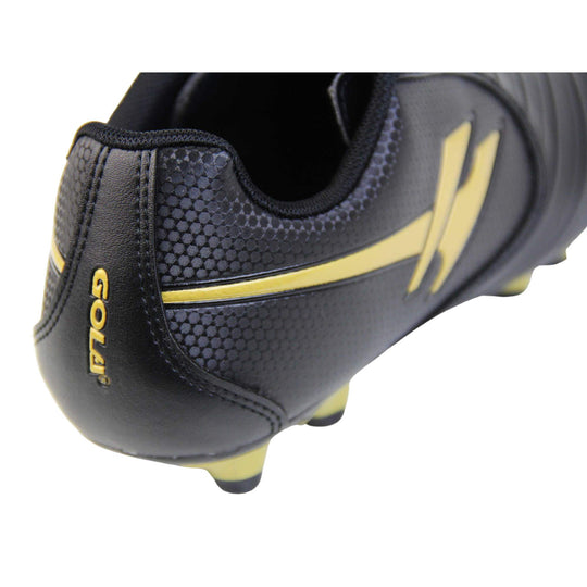 Kids football boots. Black football boots with line detailing to the toes. Lace-up fastening to the front. Gold Gola logo to the side and gold Gola branding to the tongue. Black sole with gold accents and studs to the base. Close up of back of shoe to shoe the Gola logo and gold Gola branding to the back of the shoe.