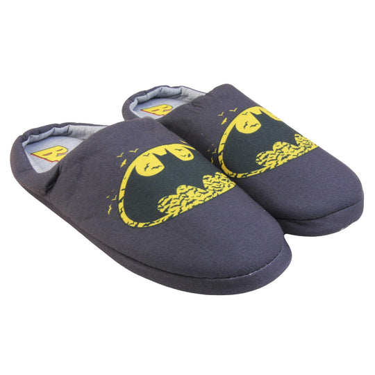 Batman slippers mens. Mule style slippers with black textile upper with a yellow Batman logo on the top. Grey textile lining and firm black sole. Both feet together at an angle.