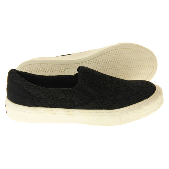 Black crochet shoes. Slip on plimsoll style shoes with a black canvas upper with a crochet overlay. Black elasticated gusset. White flat platform sole. Both feet from a side profile with the left foot on its side behind the the right foot to show the sole.