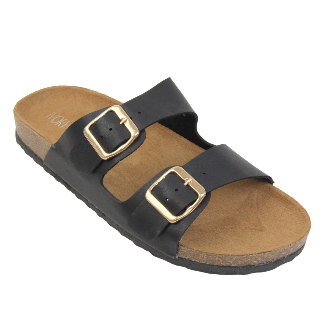 Black double strap sandals. Womens dual strap slip on sandals. With a black synthetic leather upper with a gold buckle on each strap. Brown faux suede insole with a moulded footbed. Cork effect outsole with black base with grip to the bottom. Right foot at an angle.