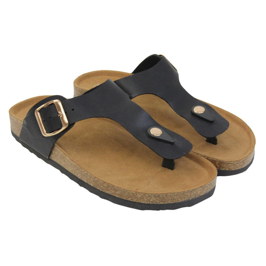 Black faux leather sandals. Black faux leather strap with toe post to the front and gold buckle to the outside. Soft tan faux suede footbed with cork effect outsole and black sole. Both feet together at a slight angle.