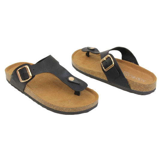Black faux leather sandals. Black faux leather strap with toe post to the front and gold buckle to the outside. Soft tan faux suede footbed with cork effect outsole and black sole.  Both feet at an angle facing top to tail.