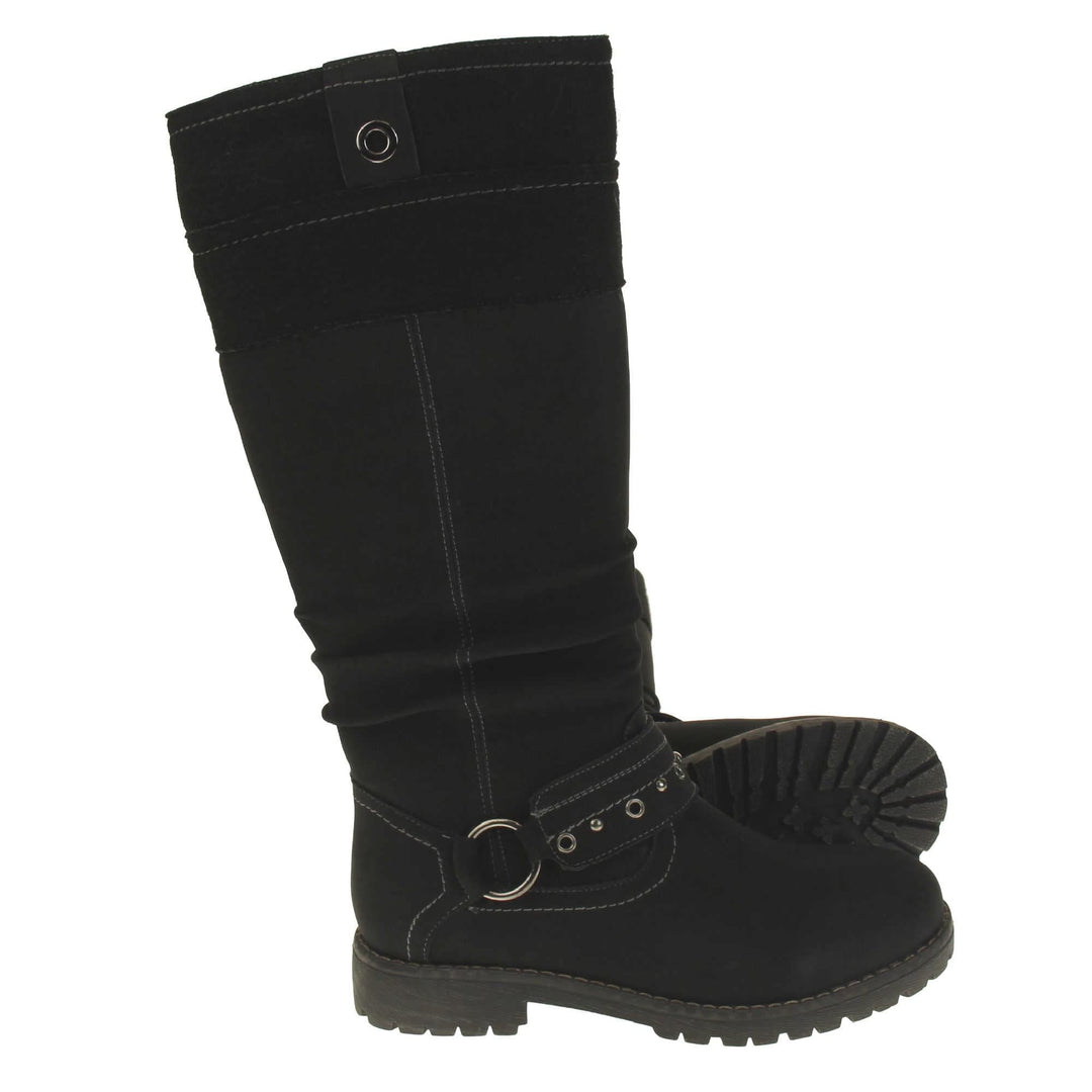 Black faux nubuck knee high boot. Tall boots with a black faux nubuck leather upper with a felt decorative cuff around the top. A strap with stud embellishment goes around the front of the ankle connected by a silver loop. Stitching detail around the outsole and the ankle. Full length zip to the inside leg. Both feet from a side profile with the left foot on its side to show the sole.