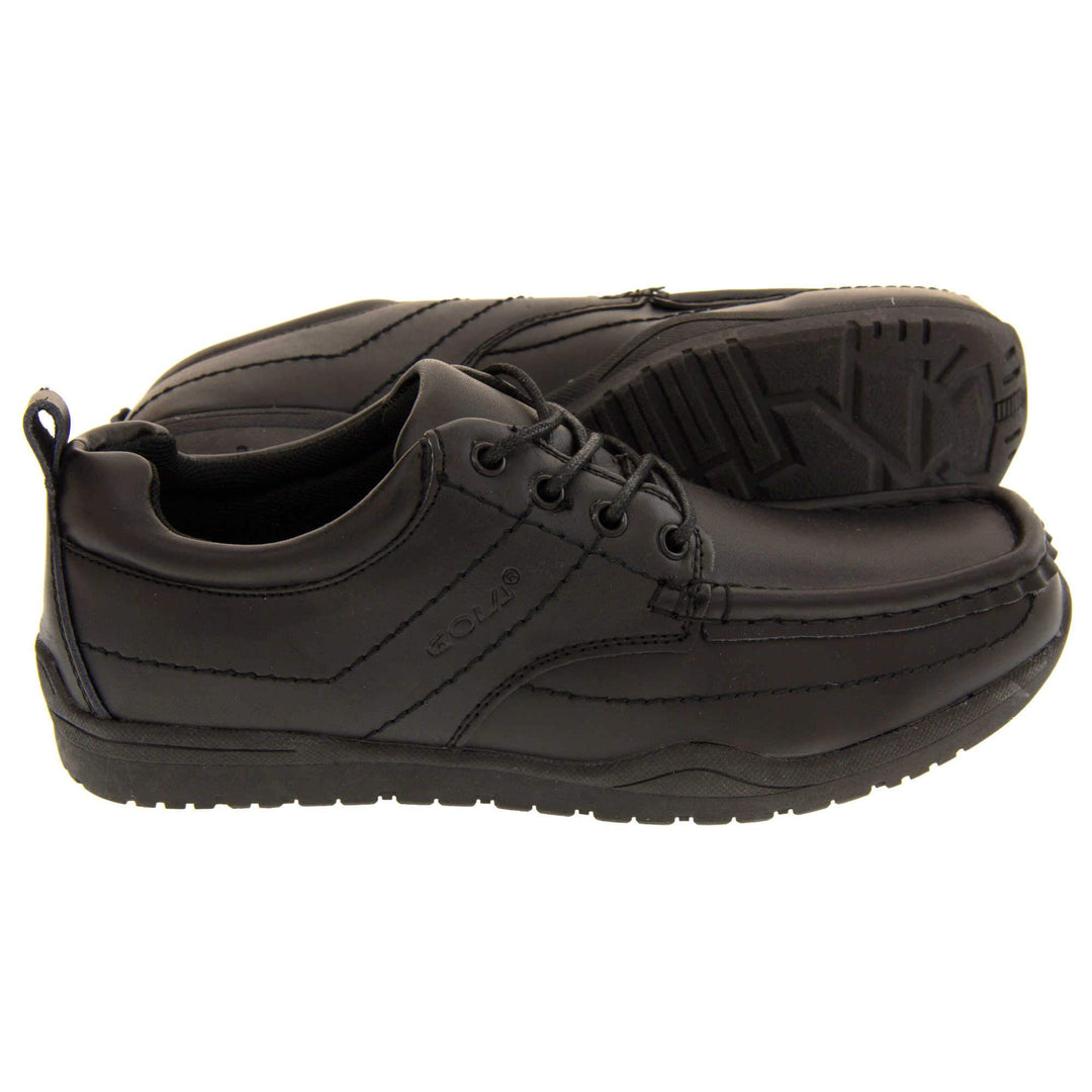 Black school shoes. Gola black leather school shoes, similar to trainer style. With stitched detailing and Gola branding embossed into the side. With black laces and a black loop on the heel to help pull the on. Black sole with good grip. Both feet from the side with left foot behind the other, on its side to show the sole.