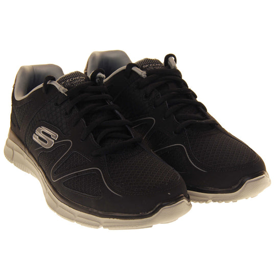 Black Skechers mens. Black mesh and leather upper with a thin wiggly grey line along the side from the toes. Black laces and grey textile lining. Grey and white Skechers logo to the side and chunky white outsole with grip. Both shoes together at an angle.