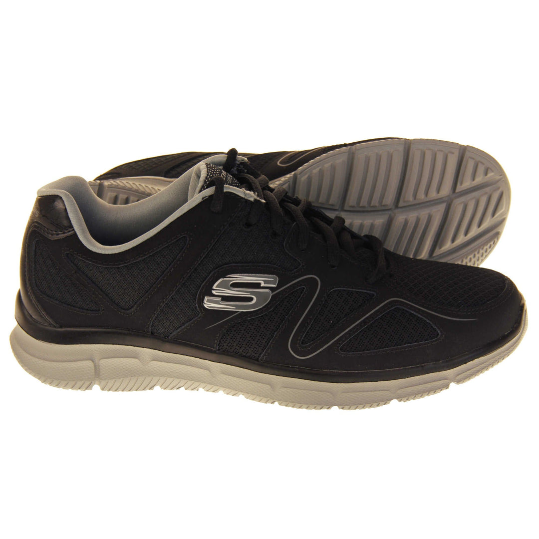 Black Skechers mens. Black mesh and leather upper with a thin wiggly grey line along the side from the toes. Black laces and grey textile lining. Grey and white Skechers logo to the side and chunky white outsole with grip.  Both feet from a side profile with the left foot on its side to show the sole.