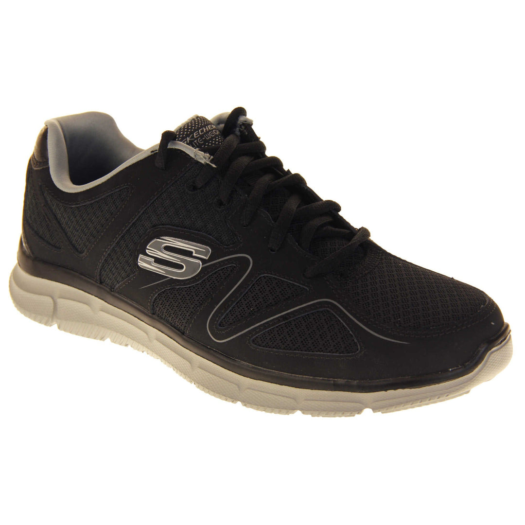 Black Skechers mens. Black mesh and leather upper with a thin wiggly grey line along the side from the toes. Black laces and grey textile lining. Grey and white Skechers logo to the side and chunky white outsole with grip. Right foot at an angle.