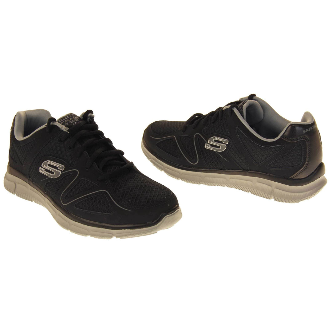 Black Skechers mens. Black mesh and leather upper with a thin wiggly grey line along the side from the toes. Black laces and grey textile lining. Grey and white Skechers logo to the side and chunky white outsole with grip. Both feet at a slight angle facing top to tail.