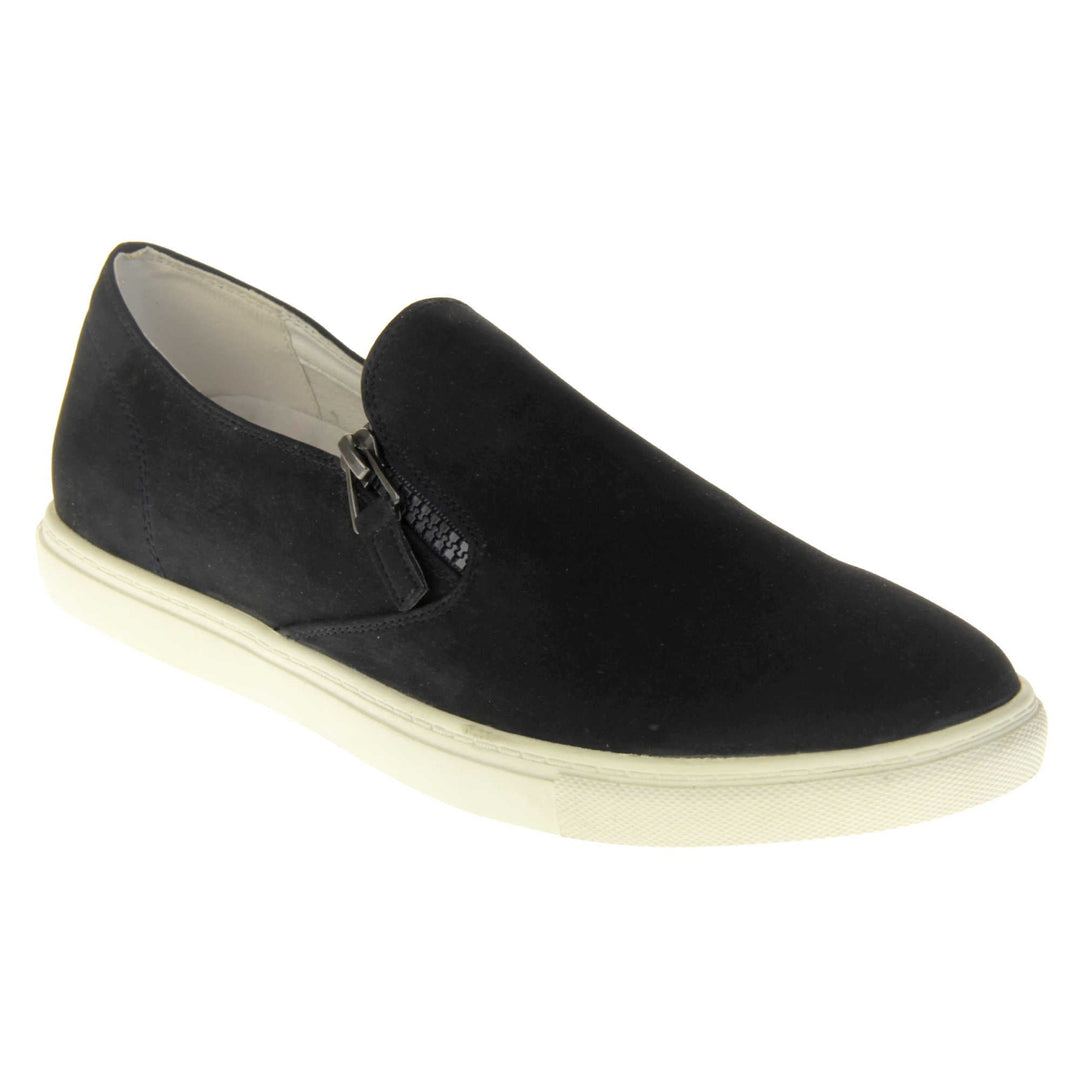 Black slip on pumps. Women's shoes with a black faux leather upper and zip detailing down the side of the tongue. White real leather lining. Thick white sole. Right foot at an angle.