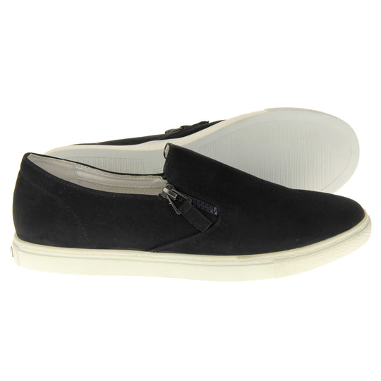 Black slip on pumps. Women's shoes with a black faux leather upper and zip detailing down the side of the tongue. White real leather lining. Thick white sole. Both feet from a side profile with the left foot on its side behind the the right foot to show the sole.