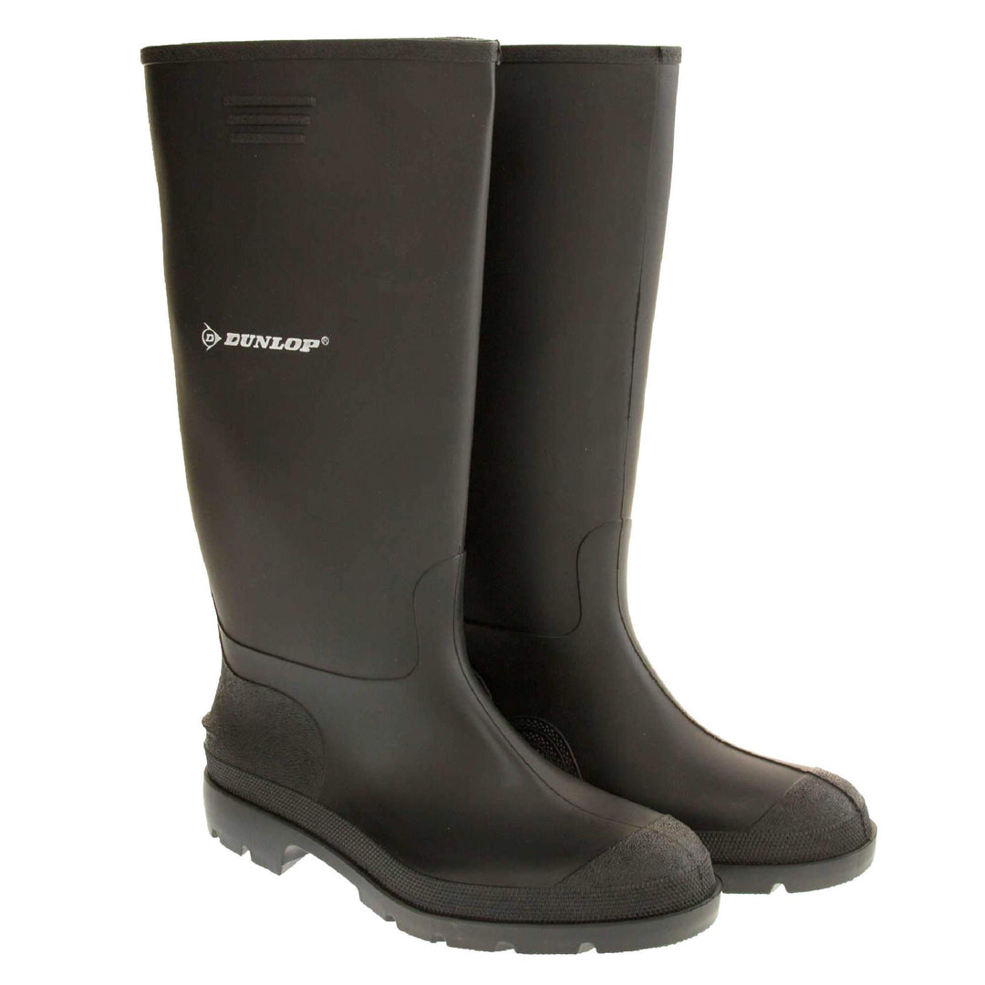 Black wellies. Black knee high wellies with a waterproof rubber upper and sole. With white Dunlop logo and brand on the side. Both feet together at an angle.