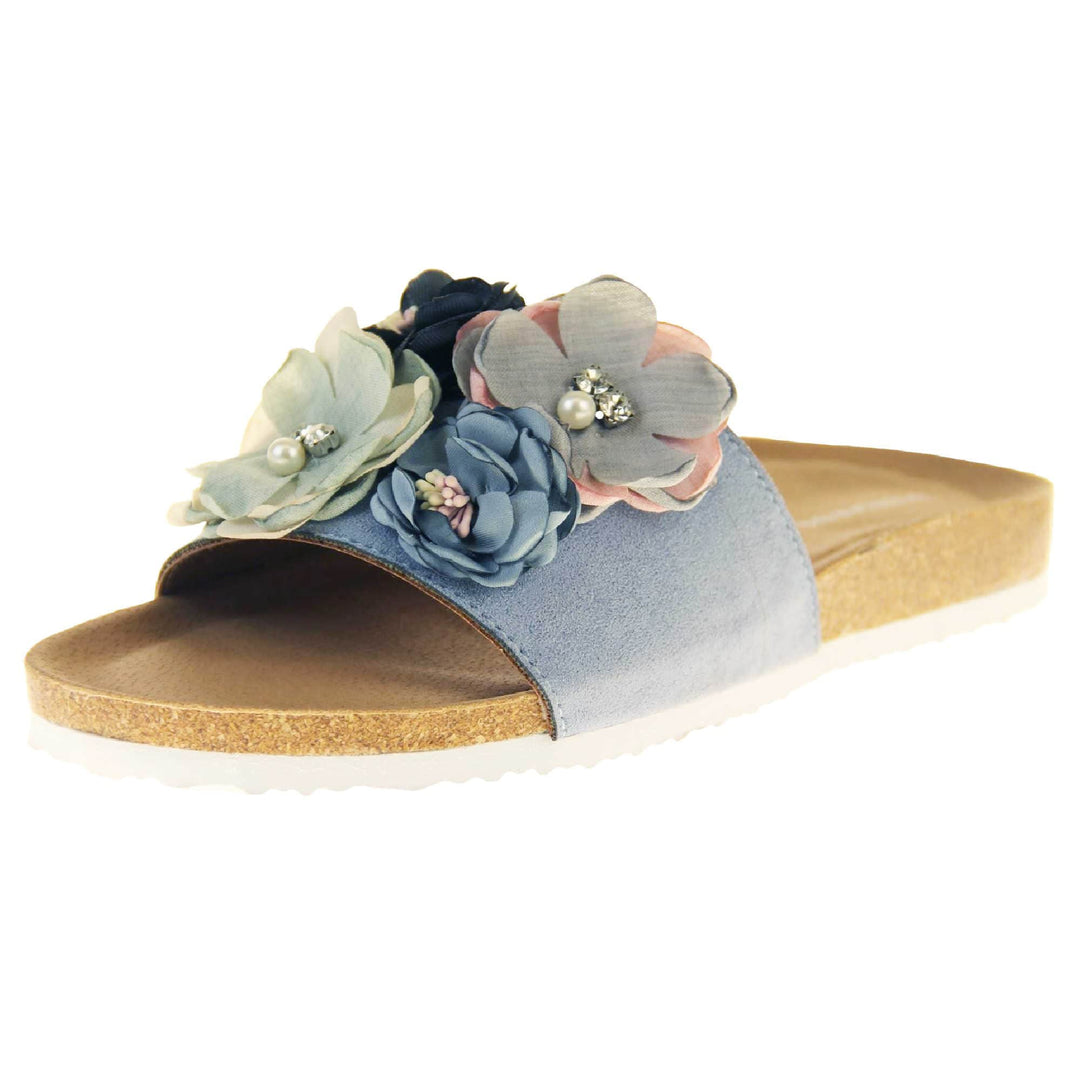 Blue Flower Sandals - Stunning festival style flowers across the top strap decorated with pearls and diamantes. Soft tan faux leather footbed sandals with white soles. Perfect for weddings, beaches, holidays or casual wear. Angled left side view.