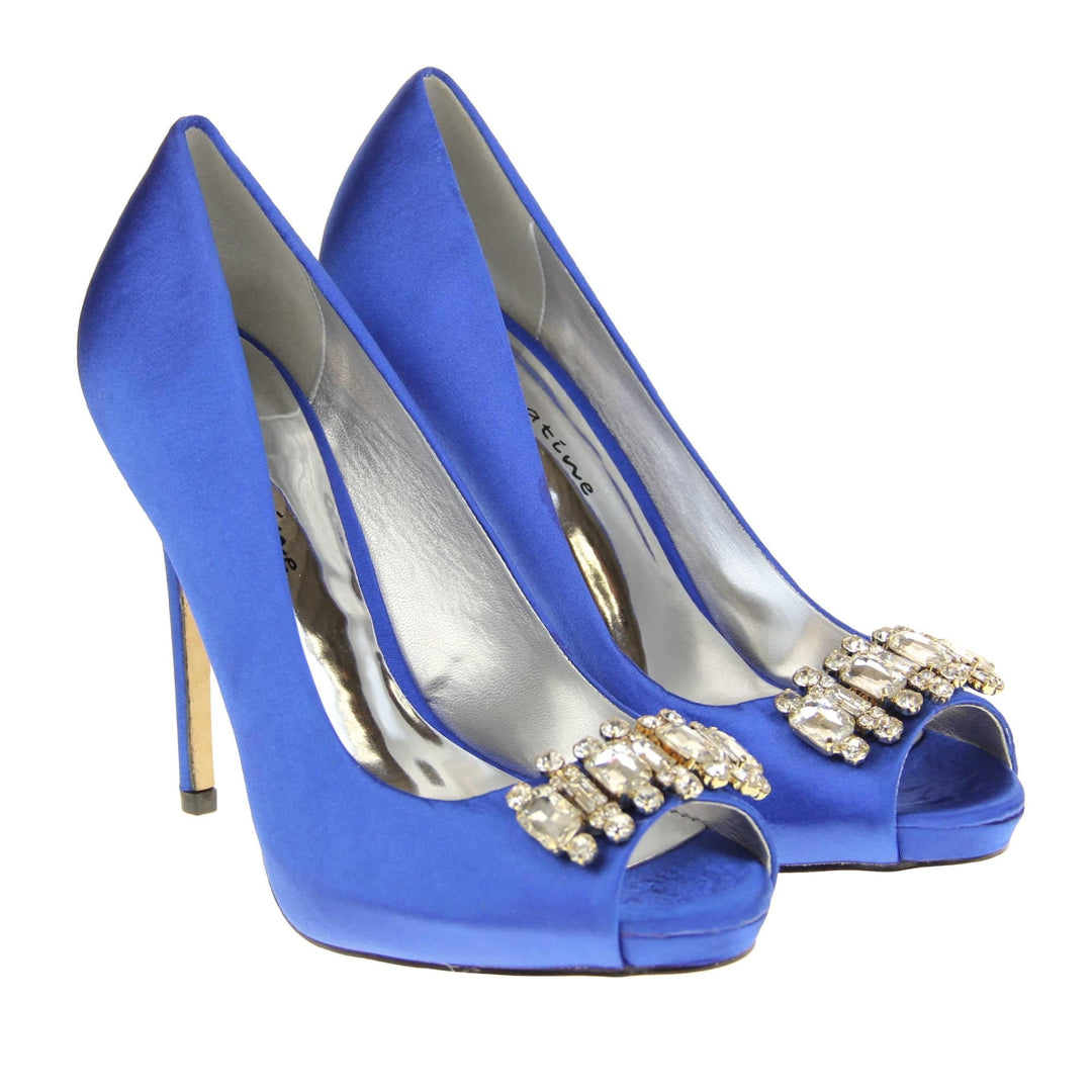 Blue peep toe shoes. Classic women's peep toe high heels with a blue satin upper. Metallic silver insole with Sabatine branding. Blue satin stiletto heel with a cream sole. Diamante cluster detailing across the toes. Both feet together at a slight angle.