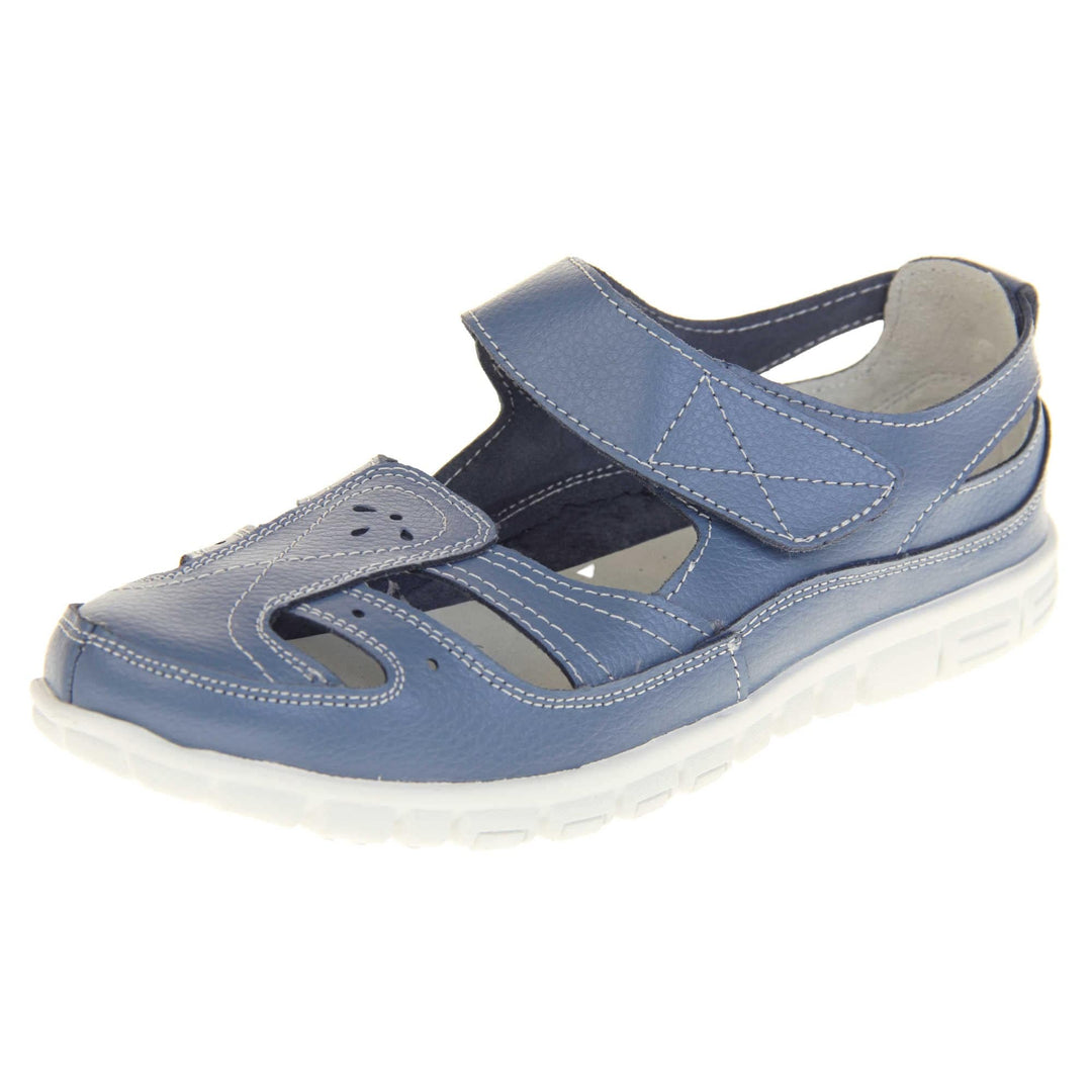 Blue wide fit sandals. Mary Jane style shoes. Blue leather uppers with white stitching detail. Blue touch fasten strap over the foot. Cut outs in the middle, edges and heel of the shoes. White sole with grip to the bottom. Left foot at an angle.