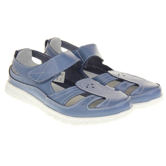 Blue wide fit sandals. Mary Jane style shoes. Blue leather uppers with white stitching detail. Blue touch fasten strap over the foot. Cut outs in the middle, edges and heel of the shoes. White sole with grip to the bottom. Both shoes together from an angle