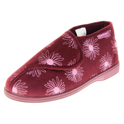 Boot slippers with hard sole. Womens bootie style slipper with a burgundy textile upper with a pink flower print. Touch fasten tab to the top and red textile lining. Firm red sole. Left foot at an angle.