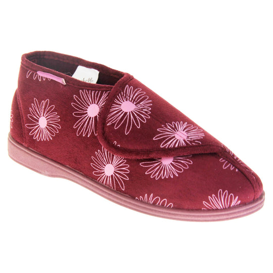 Boot slippers with hard sole. Womens bootie style slipper with a burgundy textile upper with a pink flower print. Touch fasten tab to the top and red textile lining. Firm red sole. Right foot at an angle.