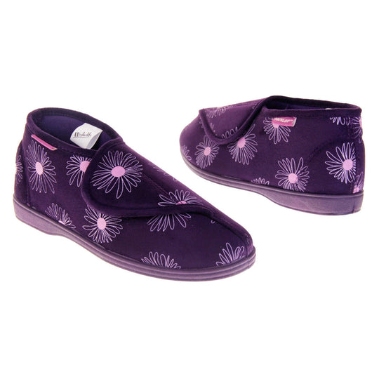 Bootie slippers. Womens bootie style slipper with a purple textile upper with a pink flower print. Touch fasten tab to the top and purple textile lining. Firm purple sole. Both feet at an angle, facing top to tail.