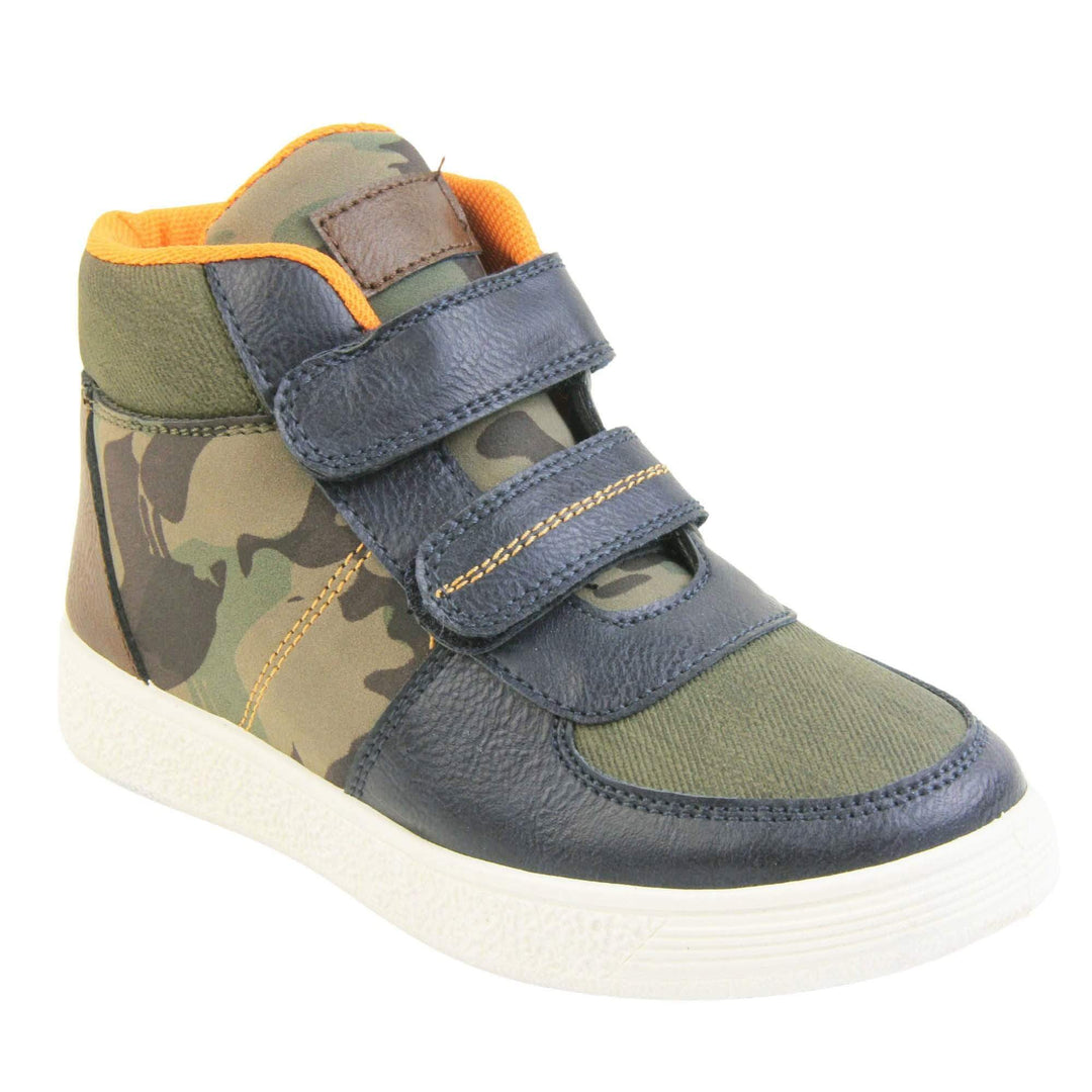 Boots for Boys. Boys canvas ankle boots with camouflage sides and tongue, khaki collar and upper toes and navy faux leather edging details. Touch fasten straps to the front with a white sole. Right foot at an angle