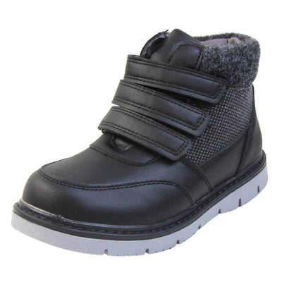 Boys Ankle Boots. Black faux leather upper with textile side panels and black faux fur collar. Three black touch fasten faux leather straps along the front. Grey synthetic sole with grip to the base. Left foot at an angle.