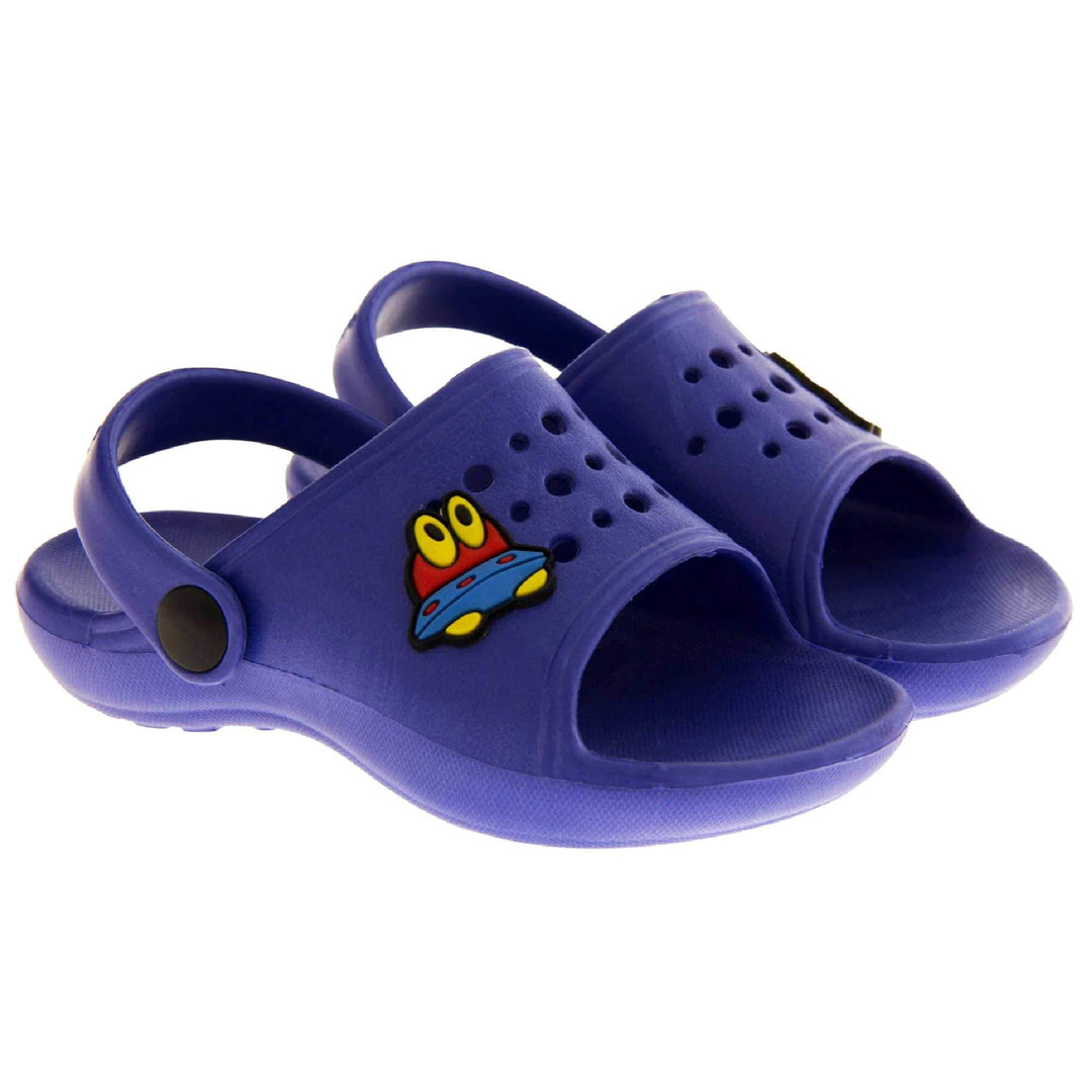 Boys Clogs. Blue synthetic clog style shoes. Open toed with cut out holes in the upper with alien detail just off centre. Blue strap that goes along the back of your heel. The strap can be moved along the top of the shoe instead to make the shoe a mule. Both shoes next to each other at a slight angle.