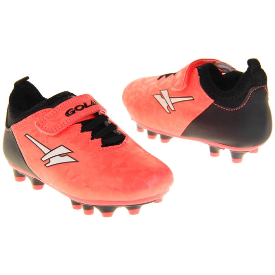 Kids football boots. Metallic red Gola boots with white Gola logo to the sides. With black heel, tongue and black elastic lace detail to the front. Red touch close strap with Gola branding across it. Black sole with red accents and studs. Both feet facing top to tail from an angle.