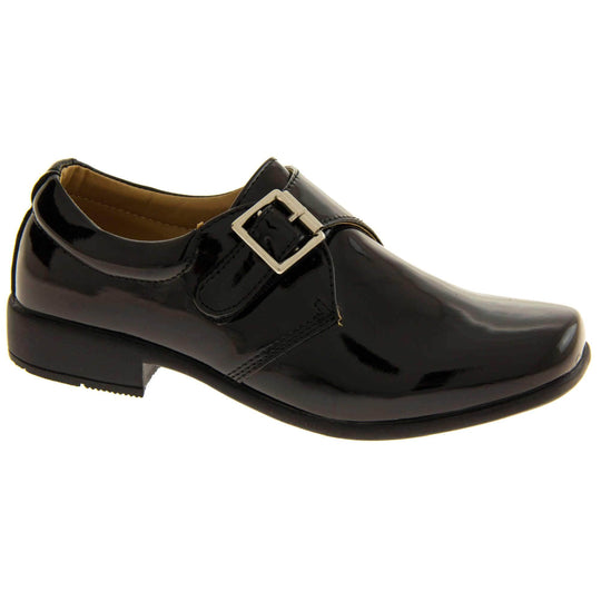 Boys Formal Shoes. Black patent monk style shoes with a buckle effect touch close fastening and a black sole. Right foot at an angle
