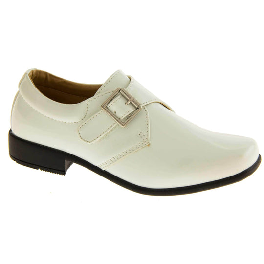 Boys Formal Shoes. White patent monk style shoes with a buckle effect touch close fastening and a black sole. Right foot at an angle