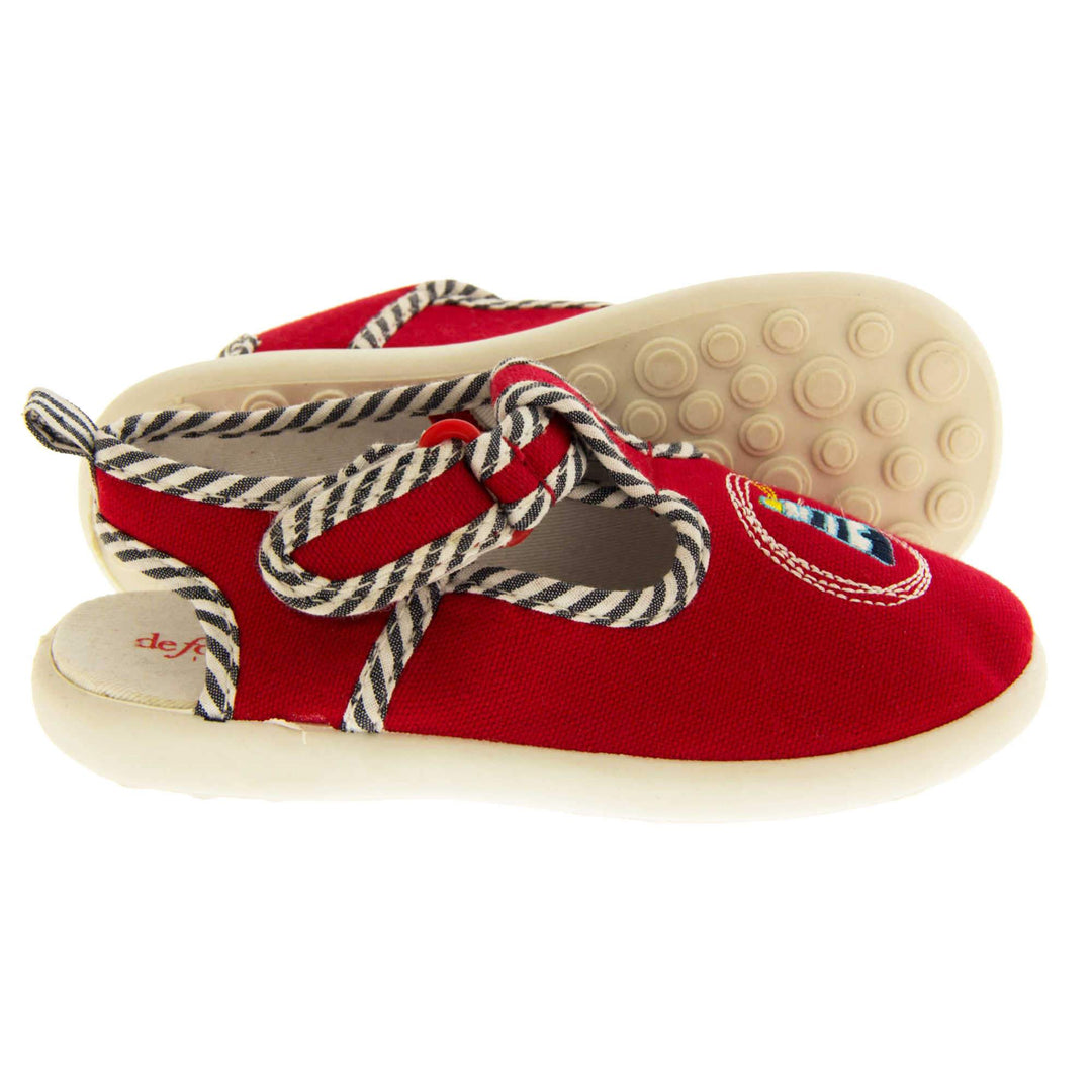 Boys sandals. Red canvas sandals with cut out heel. White sole with lighthouse detail on the front of the shoes and blue and white striped edging.  Both shoes from side profile with left foot on its side to show the sole.