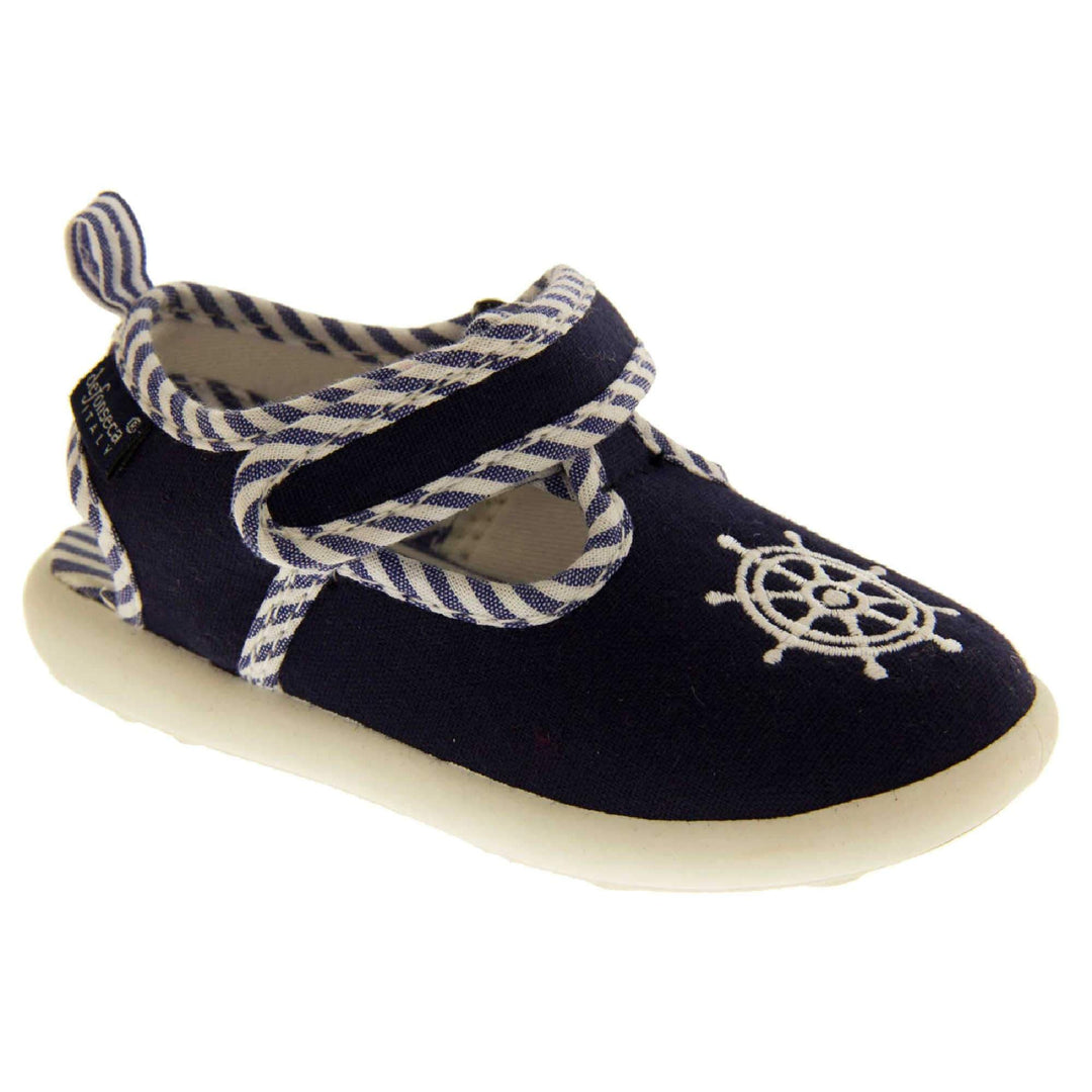 Boys sandals. Navy canvas t-bar pumps with white sole, anchor detail to the front and blue and white edging.  Right foot at angle