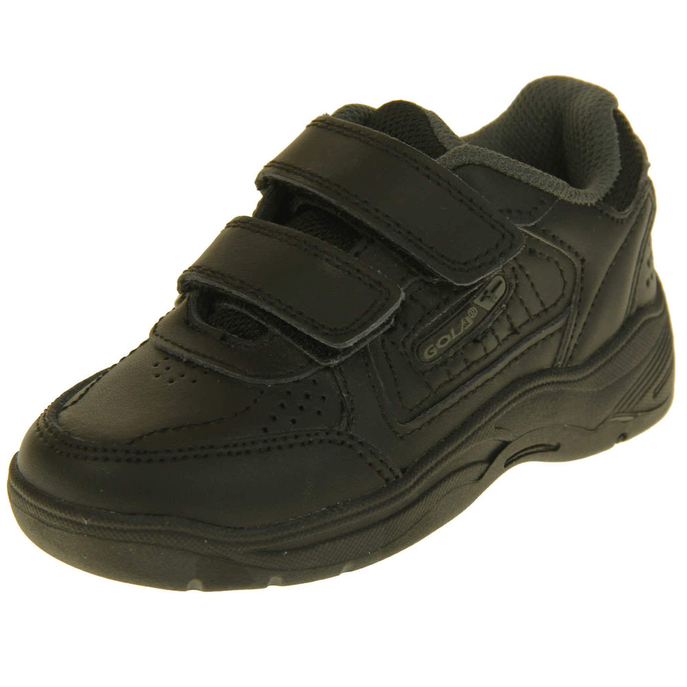 Kids trainers. Black leather Gola trainers with fabric tongue. With Gola branding and logo on the side and two touch close straps. The lining is grey textile. Black chunky sole with grip to the base. Left foot at an angle.