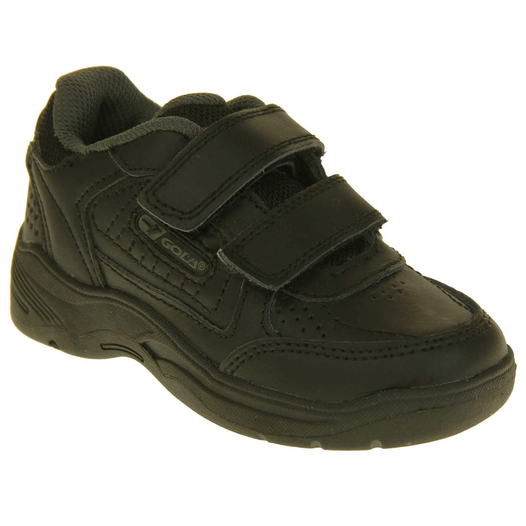 Kids trainers. Black leather Gola trainers with fabric tongue. With Gola branding and logo on the side and two touch close straps. The lining is grey textile. Black chunky sole with grip to the base. Right foot at an angle.