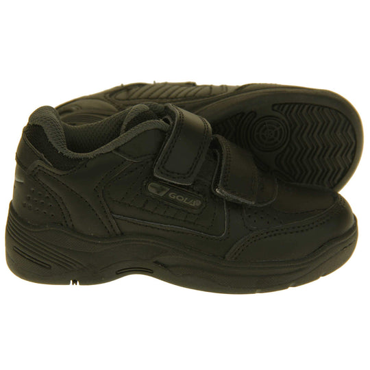 Kids trainers. Black leather Gola trainers with fabric tongue. With Gola branding and logo on the side and two touch close straps. The lining is grey textile. Black chunky sole with grip to the base. Both feet from side profile with left foot on its side to show the sole.