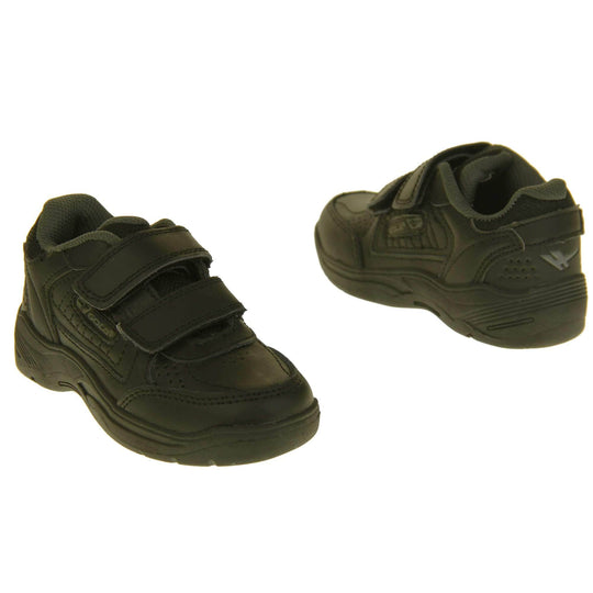 Kids trainers. Black leather Gola trainers with fabric tongue. With Gola branding and logo on the side and two touch close straps. The lining is grey textile. Black chunky sole with grip to the base. Both feet at a slight angle facing top to tail.