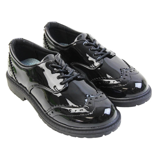 Brogue school shoes. Black patent faux leather uppers in a brogue style shoe. Black laces and lining with metallic blue insole. Black sole with very slight heel. Both feet together at an angle.