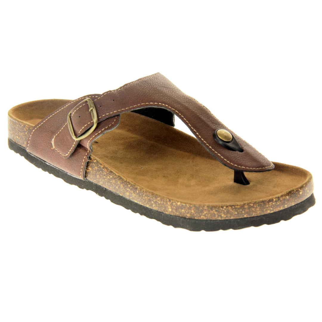 Brown buckle sandals. Dark brown faux leather strap with toe post to the front and gold buckle to the outside. Soft tan faux suede footbed with cork effect outsole and black sole. Right foot at an angle.