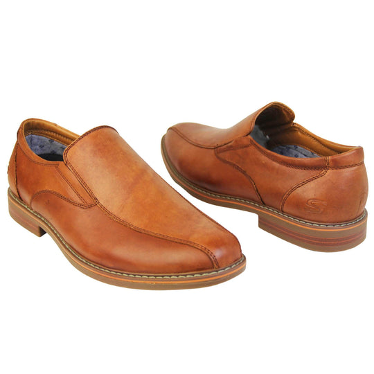 Brown dress shoes. Mens formal shoes with a smooth brown leather upper with detailed stitching and an embossed Skechers logo to the heel. Brown sole with very slight heel. Orange stripe running around the edge of the sole and orange detailing to the sole. Both feet at an angle about an inch apart facing top to tail.