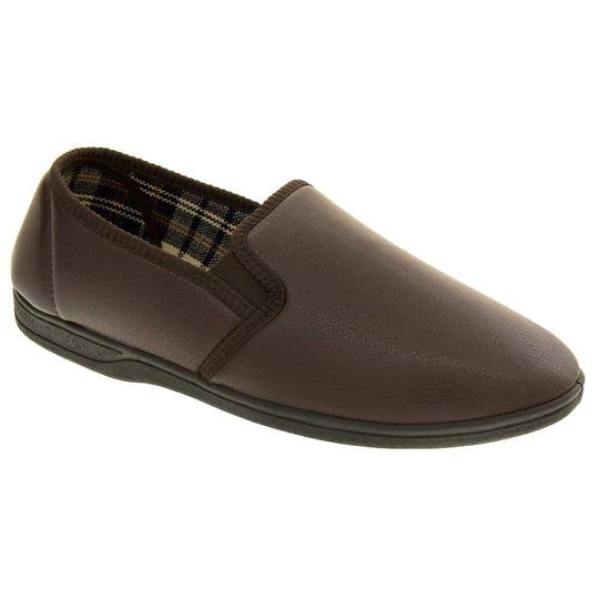 Brown faux leather slippers. Brown faux leather upper with a classic full back slipper design. Twin brown elasticated gussets to the collar of the shoe. Tartan textile lining. Black outdoor sole. Right foot from an angle.